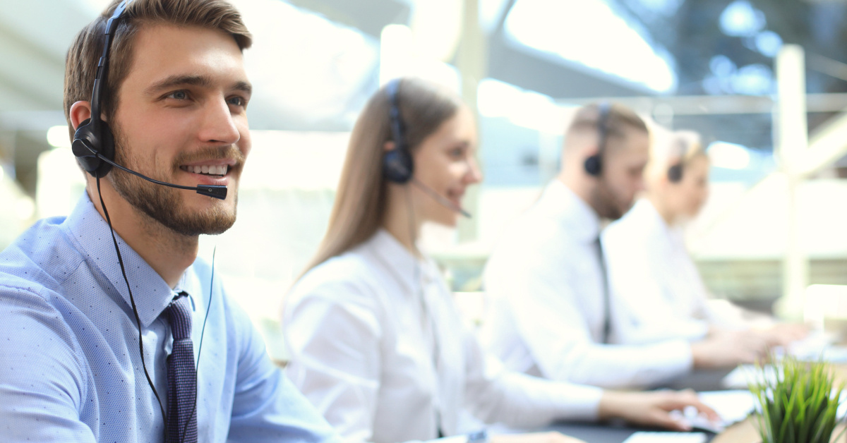 contact center agent smiling as her talks to a customer