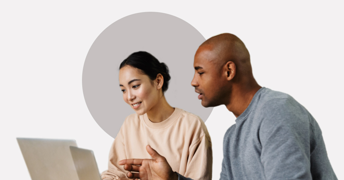 Two coworkers working together on a laptop