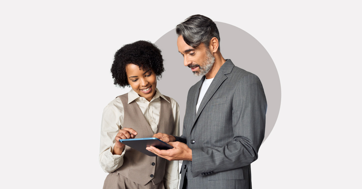 two coworkers looking at tablet